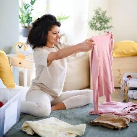woman looking at clothes to sell online